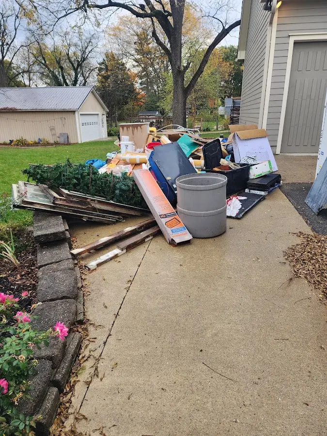 Dumpster being loaded with debris for Demolition Dumpster Rental in Holly Hill
